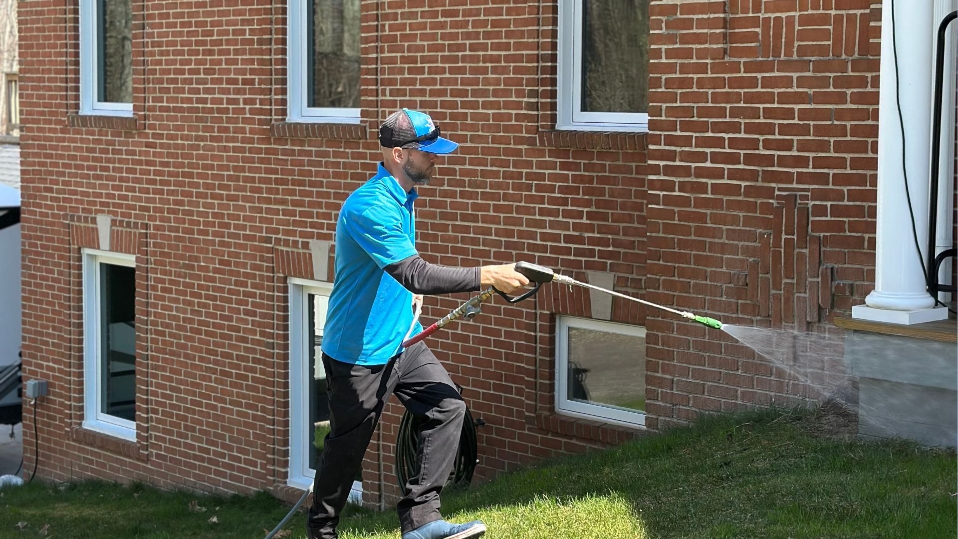 professional pressure washing siding on building
